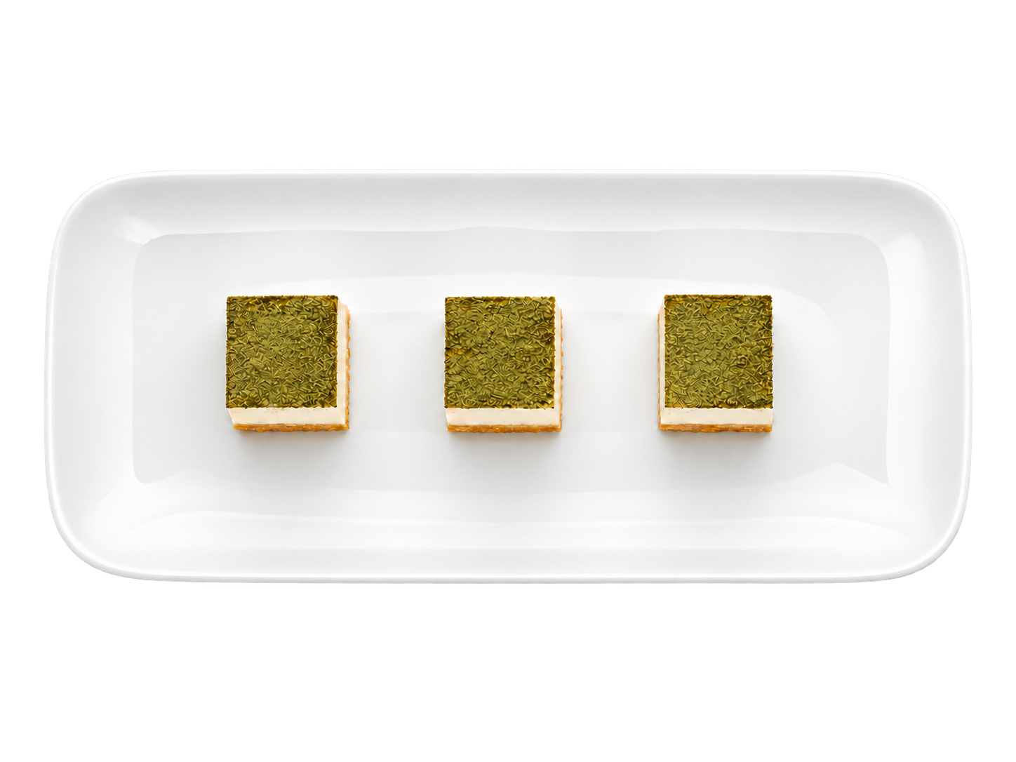 Tři sousta tofu na bílém talíři vystřižené