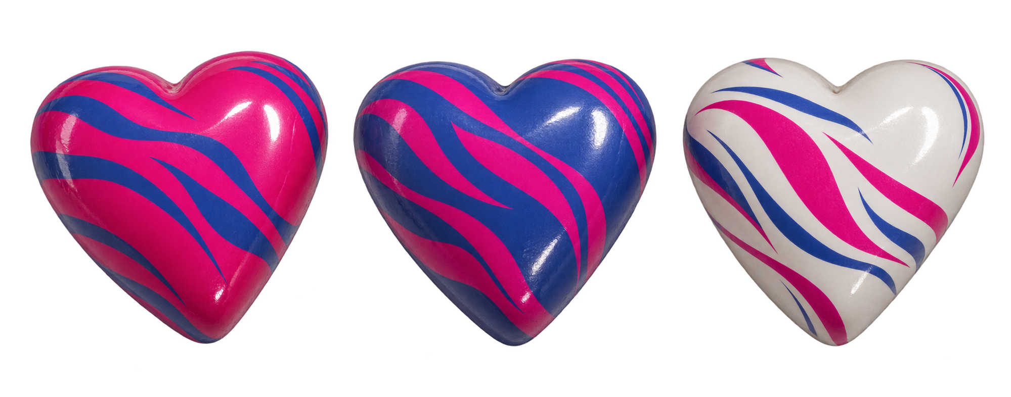 Three glossy Bousin heart chocolates in fuchsia, cobalt blue and pearl white
